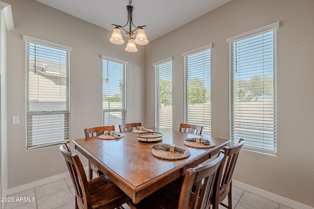 dining space with light tile patterned floors, baseboards, and a chandelier