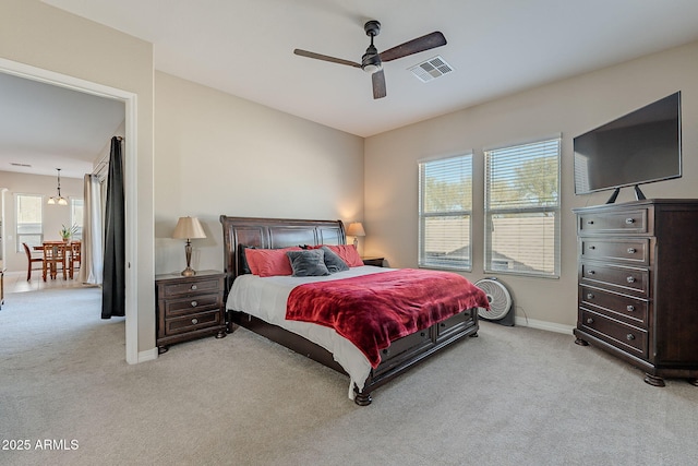 bedroom featuring baseboards, visible vents, ceiling fan, and light colored carpet