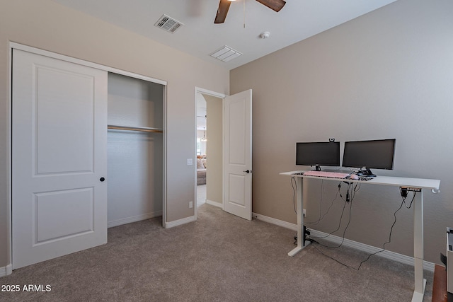 carpeted office featuring visible vents, ceiling fan, and baseboards