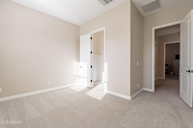 unfurnished bedroom with baseboards, visible vents, and light colored carpet