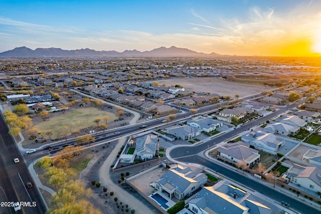 aerial view at dusk featuring a residential view and a mountain view