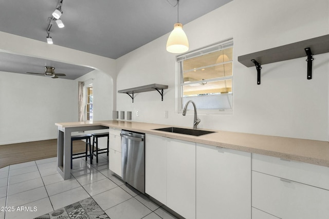 kitchen featuring light countertops, a sink, open shelves, white cabinetry, and stainless steel dishwasher