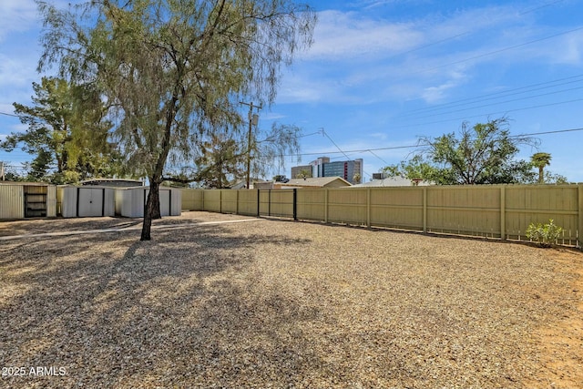view of yard featuring an outdoor structure and fence