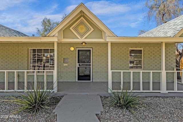 property entrance with covered porch