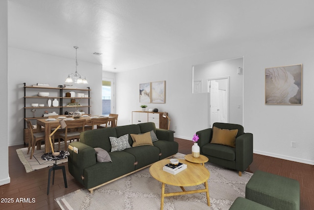 living room featuring hardwood / wood-style flooring and a notable chandelier