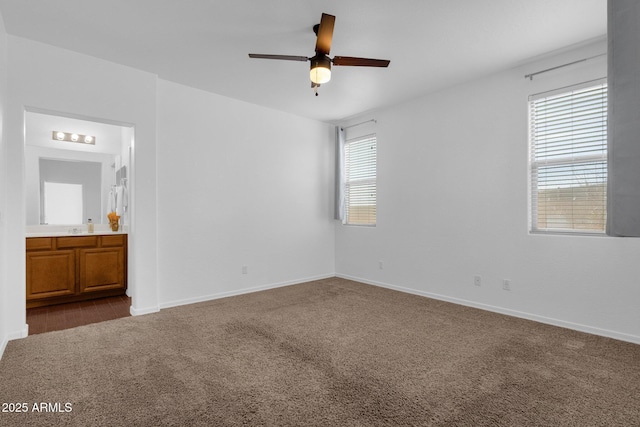 unfurnished room with ceiling fan, sink, and carpet floors