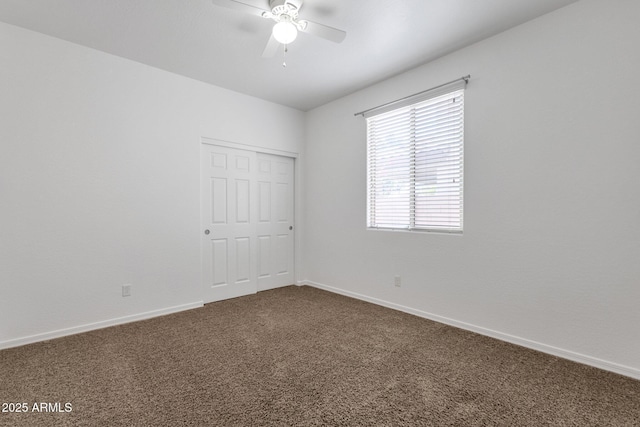 empty room with ceiling fan and carpet floors