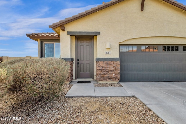 view of exterior entry featuring a garage