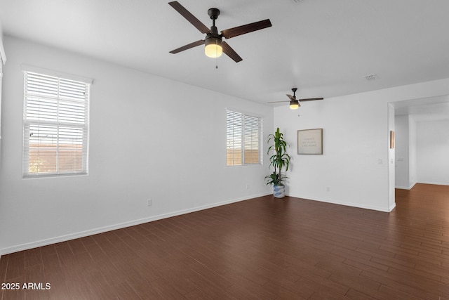 spare room with ceiling fan and dark hardwood / wood-style flooring