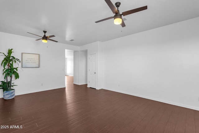 empty room featuring ceiling fan and dark hardwood / wood-style flooring