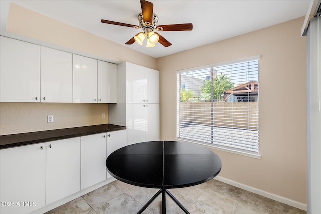 3021 E Harmony Cir, Mesa, AZ 85204 - kitchen with a ceiling fan, white cabinetry, and dark countertops