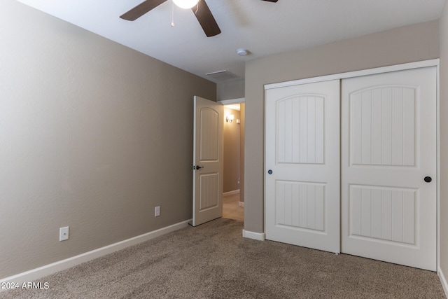 unfurnished bedroom featuring ceiling fan, carpet floors, and a closet