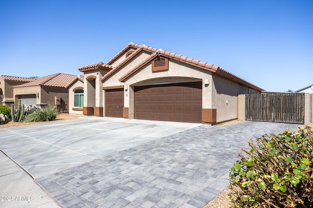 mediterranean / spanish house with a garage