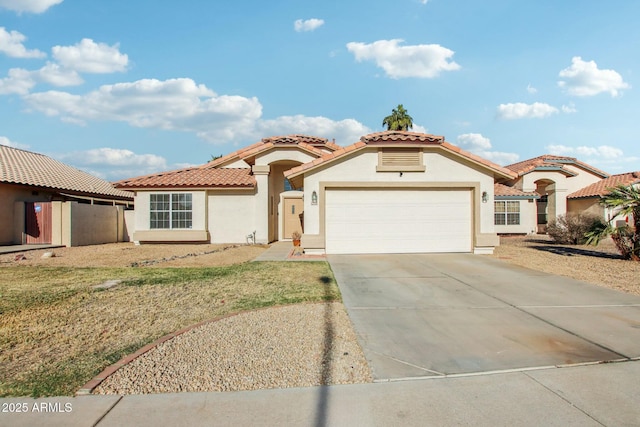 mediterranean / spanish-style home featuring a garage