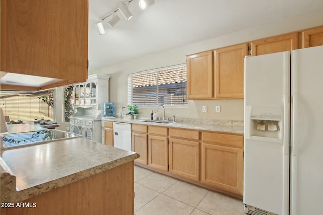 kitchen with light tile patterned flooring, white appliances, sink, and light brown cabinetry