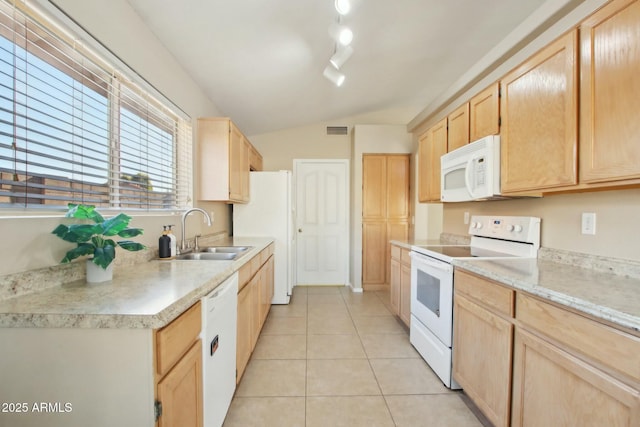 kitchen featuring sink, vaulted ceiling, white appliances, light brown cabinetry, and light tile patterned floors