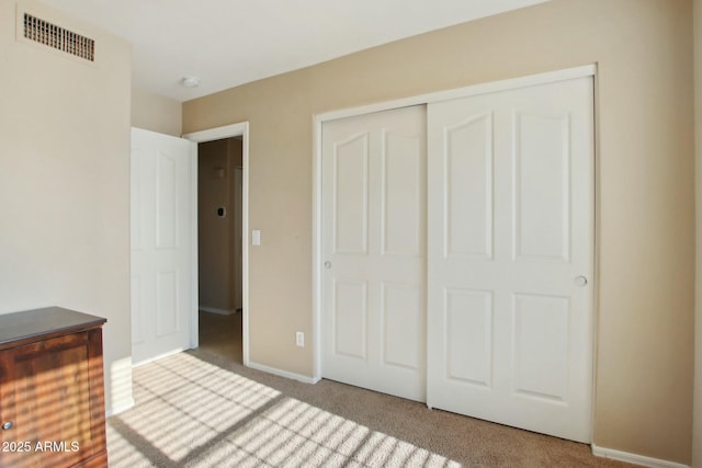 unfurnished bedroom with carpet and a closet