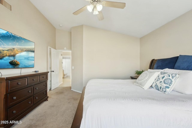 bedroom with ceiling fan, light colored carpet, and vaulted ceiling