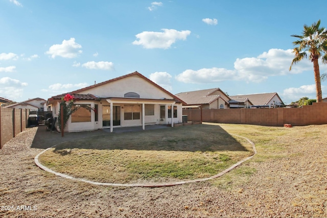 rear view of property with a lawn