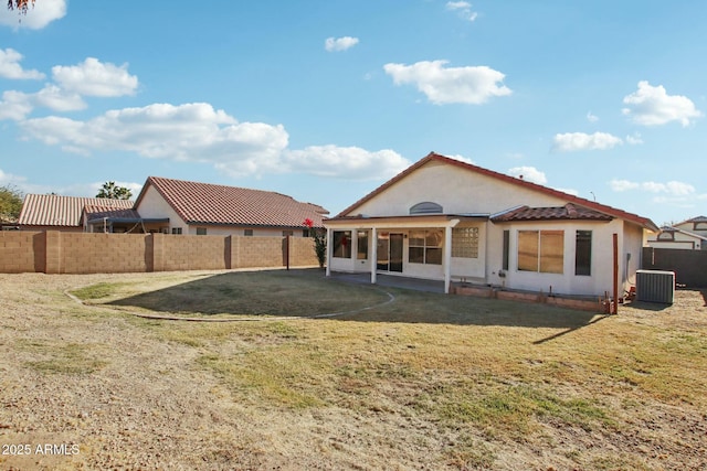 back of house featuring a yard and cooling unit