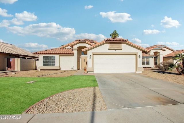 mediterranean / spanish house with a front yard and a garage