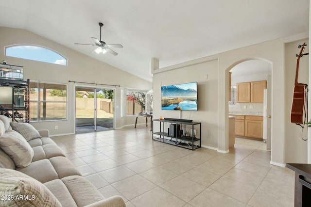 tiled living room with ceiling fan and vaulted ceiling