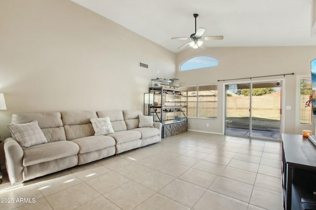 tiled living room with ceiling fan and high vaulted ceiling