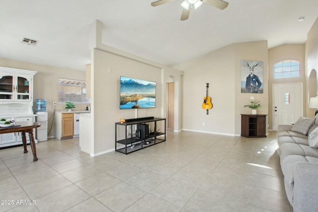 tiled living room featuring ceiling fan and a healthy amount of sunlight