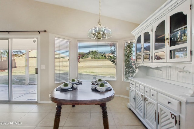 sunroom with an inviting chandelier and lofted ceiling