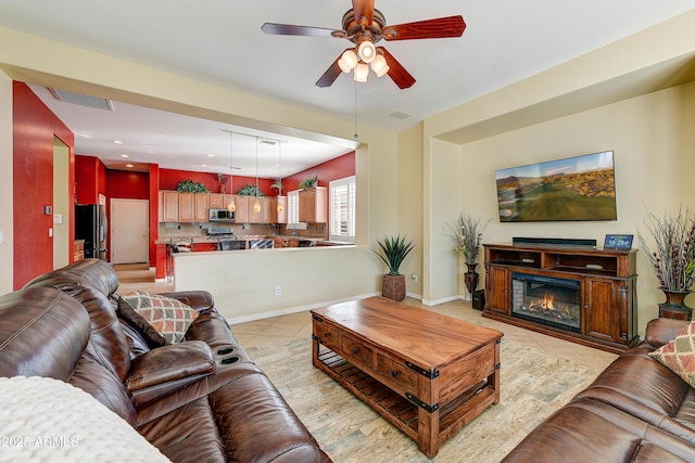 living room with light tile patterned flooring and ceiling fan