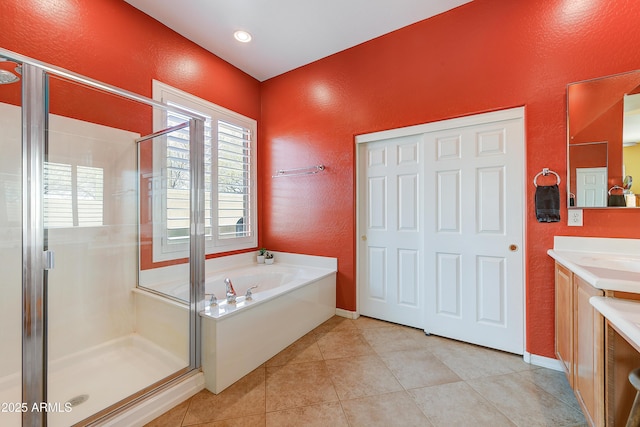 bathroom featuring vanity, tile patterned floors, and plus walk in shower