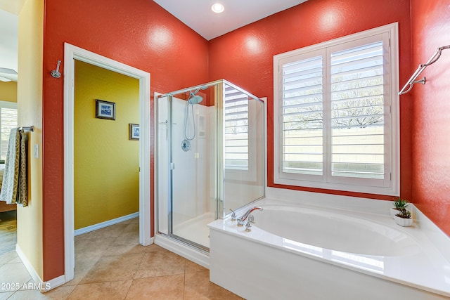 bathroom featuring tile patterned flooring, plenty of natural light, and plus walk in shower