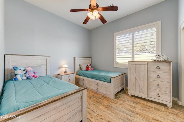 bedroom with light hardwood / wood-style floors and ceiling fan