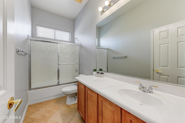 full bathroom featuring vanity, tile patterned floors, toilet, and combined bath / shower with glass door