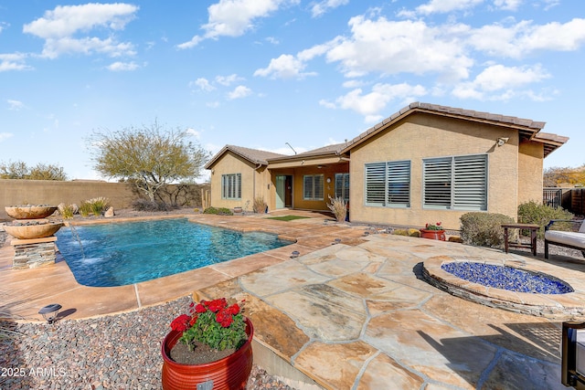 view of swimming pool with pool water feature and a patio area