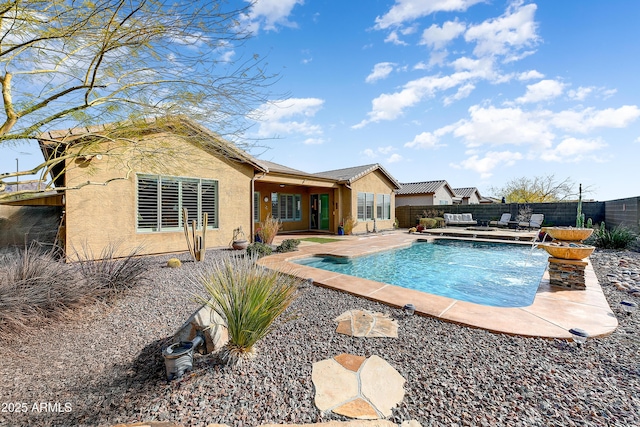 view of pool with a patio area and pool water feature