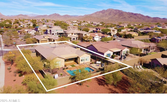 birds eye view of property with a mountain view