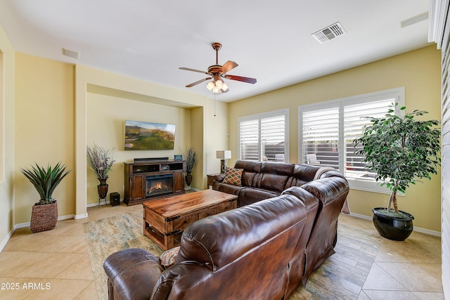 tiled living room featuring ceiling fan