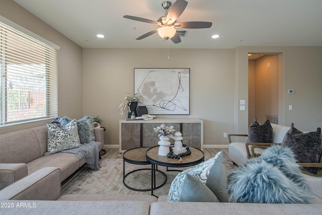 living room featuring ceiling fan and light hardwood / wood-style flooring