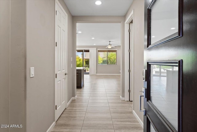 hall featuring light tile patterned flooring