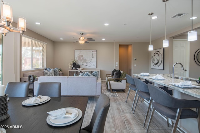 dining room featuring ceiling fan and sink