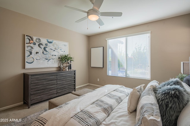 bedroom featuring light carpet and ceiling fan