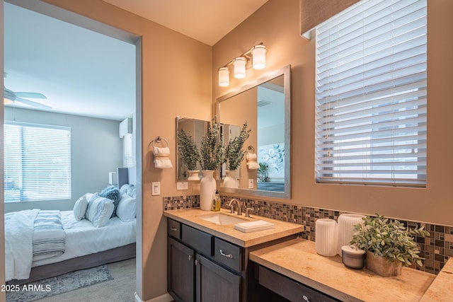 bathroom featuring ceiling fan, tasteful backsplash, and vanity