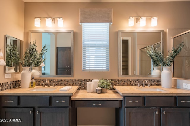 bathroom featuring walk in shower and vanity