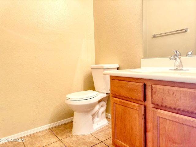 bathroom featuring tile patterned flooring, vanity, and toilet