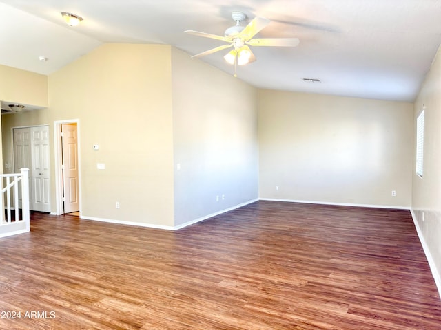 spare room with ceiling fan, wood-type flooring, and vaulted ceiling