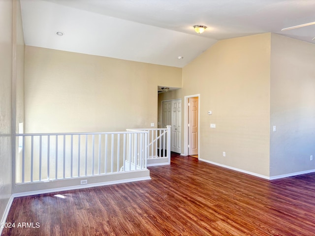 unfurnished room with lofted ceiling and dark hardwood / wood-style floors