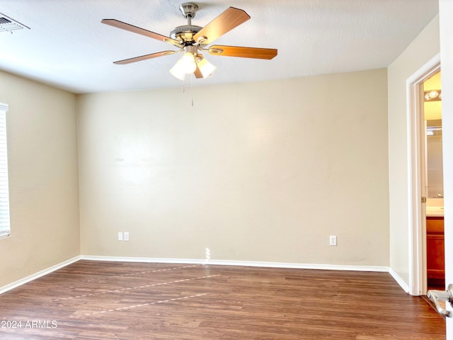 empty room featuring dark hardwood / wood-style flooring and ceiling fan