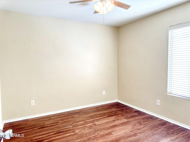 spare room with hardwood / wood-style floors and ceiling fan