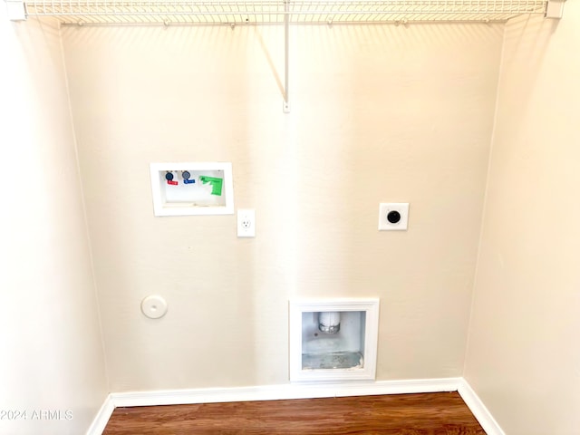 laundry room with hardwood / wood-style flooring, electric dryer hookup, hookup for a gas dryer, and hookup for a washing machine